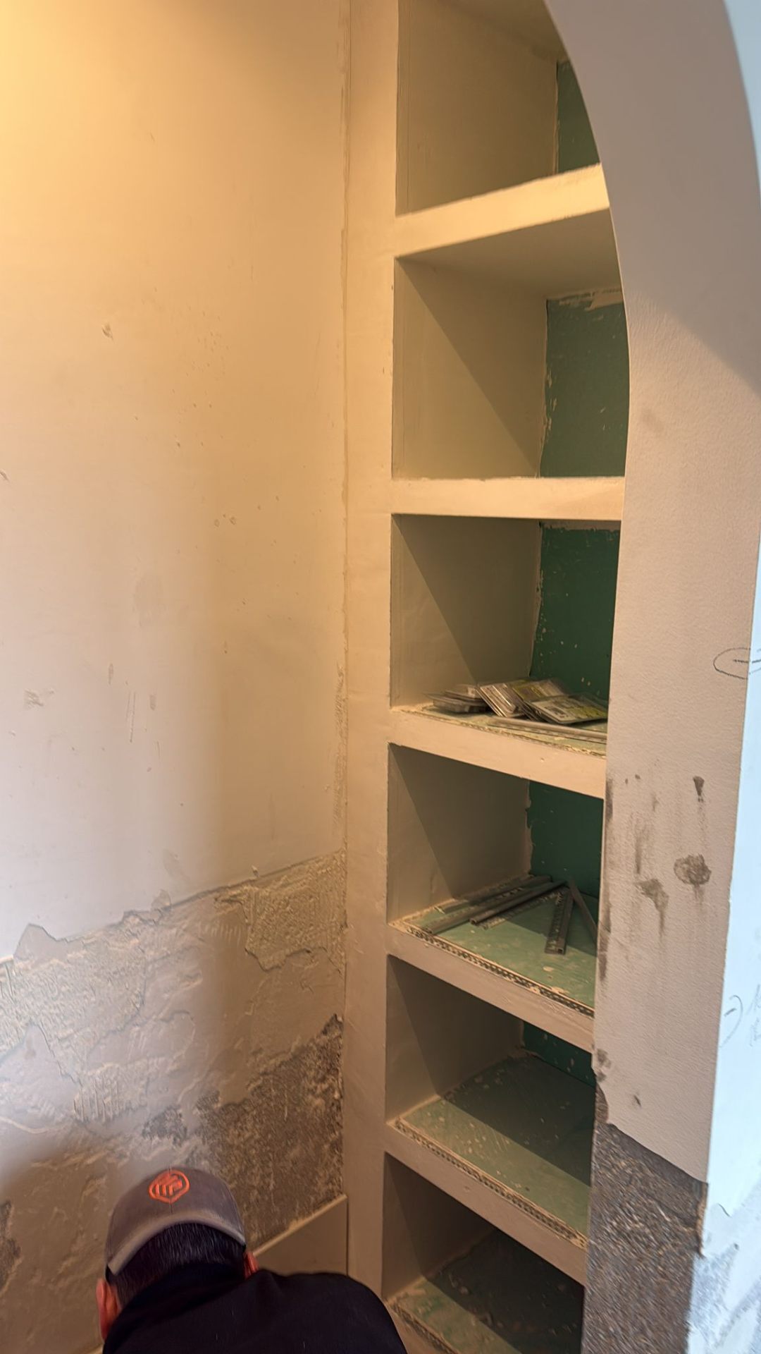 Arched alcove re-plastered over an old damp masonry wall during a heritage refurbishment